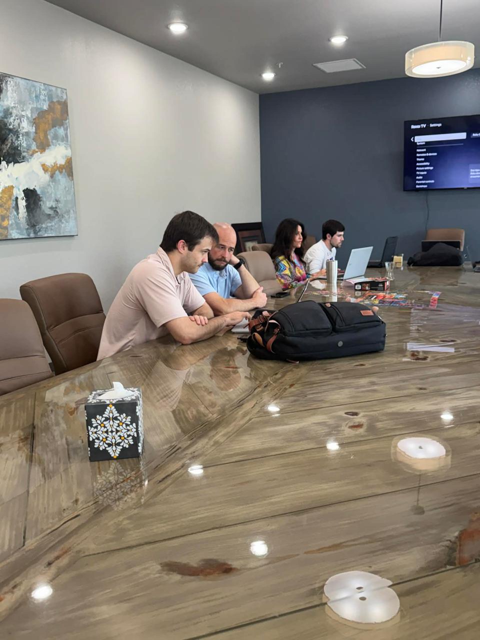 Tal leading an AI workshop in a boardroom setting
