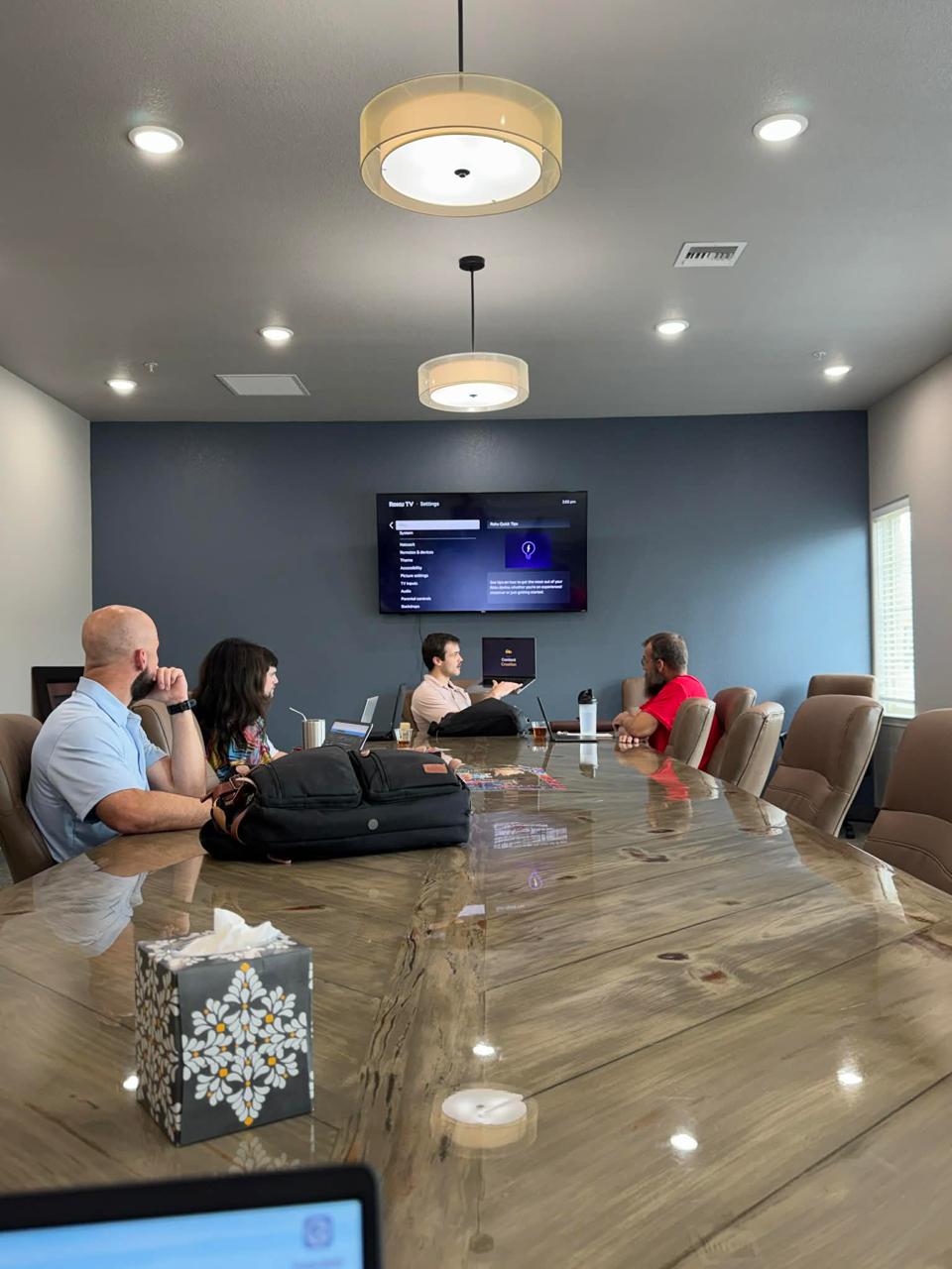 Tal presenting AI training to a room of business leaders